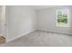 This bedroom has a neutral carpet and a large window with a view at 20 Bold Dr, Youngsville, NC 27596