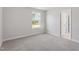 Bedroom features neutral carpet, large window, and white door at 20 Bold Dr, Youngsville, NC 27596