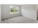 Bedroom features neutral carpet, large window, and white trim at 20 Bold Dr, Youngsville, NC 27596