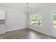 Bright dining area with wood floors, a modern chandelier, and views of the outdoors at 20 Bold Dr, Youngsville, NC 27596