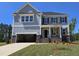 Beautiful home with gray siding, stone accents, and an attached two-car garage at 20 Bold Dr, Youngsville, NC 27596