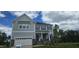Charming two-story home showcasing stone accents, a two-car garage and manicured lawn under a partly cloudy sky at 20 Bold Dr, Youngsville, NC 27596