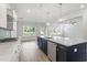 Open kitchen featuring white cabinets, stainless steel appliances, and a large center island with seating at 20 Bold Dr, Youngsville, NC 27596