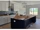 Open-concept kitchen with a large island and modern lighting fixtures at 20 Bold Dr, Youngsville, NC 27596