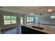 Bright, spacious kitchen island with modern lighting fixtures and view to the great room at 20 Bold Dr, Youngsville, NC 27596