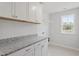 Laundry room featuring stone countertops and white cabinets at 20 Bold Dr, Youngsville, NC 27596