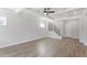 Spacious living room with wood floors, a ceiling fan, and natural light at 20 Bold Dr, Youngsville, NC 27596