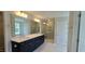 Luxurious main bathroom with double sink vanity, quartz countertops, and a glass-enclosed shower at 20 Bold Dr, Youngsville, NC 27596