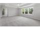Bright primary bedroom featuring a trey ceiling and a view to the exterior at 20 Bold Dr, Youngsville, NC 27596