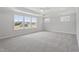 Spacious primary bedroom with tray ceiling and large windows overlooking the property at 20 Bold Dr, Youngsville, NC 27596