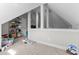 This attic space features a sloped ceiling, support beams, storage shelves, and carpet flooring at 2021 Terri Creek Dr, Fuquay Varina, NC 27526