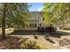 Private backyard featuring a wooden deck, mature trees and ample space for outdoor seating and entertainment at 2021 Terri Creek Dr, Fuquay Varina, NC 27526