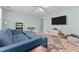 Bedroom featuring a ceiling fan, blue sofa, TV, and lots of natural light at 2021 Terri Creek Dr, Fuquay Varina, NC 27526