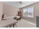 Bedroom with a single bed, desk, ceiling fan, neutral paint, and a large window at 2021 Terri Creek Dr, Fuquay Varina, NC 27526