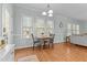 Charming breakfast nook features hardwood floors, natural light, and a stylish chandelier above a wood table at 2021 Terri Creek Dr, Fuquay Varina, NC 27526