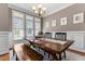 Dining room featuring a dark wooden table, bench, natural light and wainscoting at 2021 Terri Creek Dr, Fuquay Varina, NC 27526