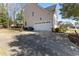 Spacious home with a large driveway, two-car garage, basketball hoop and mature trees surrounding the property at 2021 Terri Creek Dr, Fuquay Varina, NC 27526
