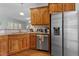 Kitchen featuring wooden cabinets, stainless steel appliances and granite countertops at 2021 Terri Creek Dr, Fuquay Varina, NC 27526