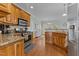 Bright kitchen with granite countertops, wooden cabinets, stainless steel appliances and eat-in area at 2021 Terri Creek Dr, Fuquay Varina, NC 27526