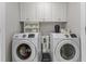 Laundry room with a front-loading washer and dryer and built-in cabinets at 2021 Terri Creek Dr, Fuquay Varina, NC 27526