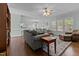 Open-concept living area features hardwood floors, a ceiling fan, and ample seating for entertaining guests at 2021 Terri Creek Dr, Fuquay Varina, NC 27526
