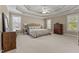 Spacious main bedroom with tray ceiling, neutral walls, carpet, and ample natural light at 2021 Terri Creek Dr, Fuquay Varina, NC 27526
