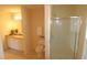 Bright bathroom featuring a tiled floor, granite countertop, and glass-enclosed shower at 2500 Friedland Pl # 101, Raleigh, NC 27617