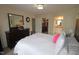 A bedroom featuring a large bed, dresser with mirror, and access to closet and bathroom at 2500 Friedland Pl # 101, Raleigh, NC 27617
