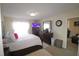 Bright bedroom featuring a large bed, dresser with mirror, and a wall-mounted TV at 2500 Friedland Pl # 101, Raleigh, NC 27617