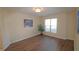Bright room with hardwood floors, large windows, and a decorative tree at 2500 Friedland Pl # 101, Raleigh, NC 27617