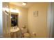 Compact half-bathroom with a pedestal sink and toilet, offering practicality and convenience for guests at 2500 Friedland Pl # 101, Raleigh, NC 27617