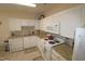Well-maintained kitchen with white cabinets, granite countertops, and modern appliances, blending functionality with classic style at 2500 Friedland Pl # 101, Raleigh, NC 27617