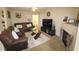 Cozy living room featuring a brown leather couch, fireplace, and neutral decor at 2500 Friedland Pl # 101, Raleigh, NC 27617