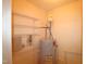 Practical utility room with water heater and shelving, offering efficient space for storage and maintenance equipment at 2500 Friedland Pl # 101, Raleigh, NC 27617