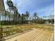 The wooden back deck overlooking the treeline and backyard at 255 Constellation Ct, Benson, NC 27504