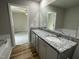 Bathroom with double sink vanity, granite counters, and wood-look vinyl flooring at 255 Constellation Ct, Benson, NC 27504