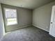 Bedroom with large window providing natural light and plush carpeting at 255 Constellation Ct, Benson, NC 27504