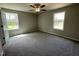 A sun-filled bedroom with a ceiling fan and neutral carpeting at 255 Constellation Ct, Benson, NC 27504