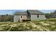 Back of the house showing gray siding and wooden back deck at 255 Constellation Ct, Benson, NC 27504