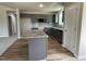 Modern kitchen featuring granite countertops, an island, gray cabinets, and stainless steel appliances at 255 Constellation Ct, Benson, NC 27504