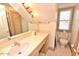 Bathroom featuring a large mirror, vanity, and a toilet under the window at 29 Mocking Ln, Rocky Mount, NC 27804
