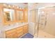 Well-lit bathroom features double sinks, cabinets, and a glass door shower at 29 Mocking Ln, Rocky Mount, NC 27804
