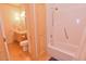 Bathroom with wood cabinets, shower over tub, and modern lighting at 29 Mocking Ln, Rocky Mount, NC 27804