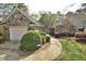Charming stone and siding home with a well-manicured lawn and lovely landscaping at 29 Mocking Ln, Rocky Mount, NC 27804