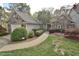 Charming stone and siding home with a well-manicured lawn and lovely landscaping at 29 Mocking Ln, Rocky Mount, NC 27804