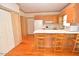 Charming kitchen features wood cabinets, breakfast bar, and hardwood floors at 29 Mocking Ln, Rocky Mount, NC 27804