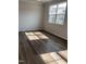Bright bedroom with hardwood flooring and a large window showcasing the neighborhood at 3007 Honeymyrtle Ln, Durham, NC 27703