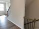 Hallway features hardwood floors and a staircase with elegant black metal spindles at 3007 Honeymyrtle Ln, Durham, NC 27703