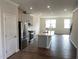 Open-concept kitchen with stainless steel appliances, a center island, and hardwood flooring at 3007 Honeymyrtle Ln, Durham, NC 27703
