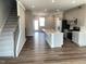 Bright, open kitchen featuring an island, modern cabinets, stainless steel appliances, and hardwood floors at 3007 Honeymyrtle Ln, Durham, NC 27703